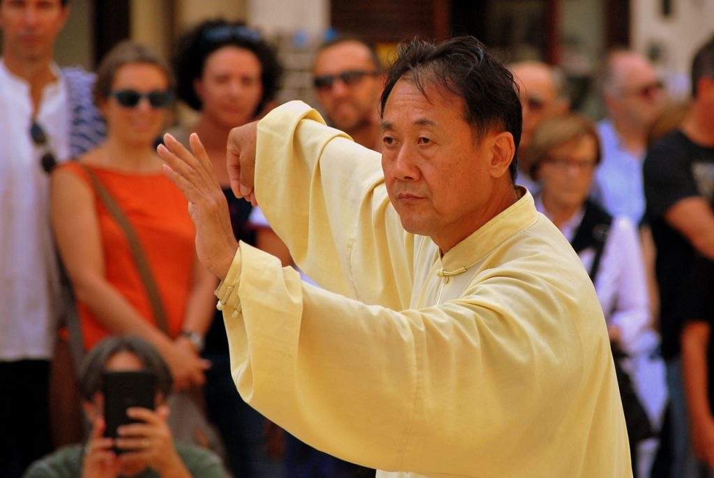 A man doing tai chi (a type of meditation)